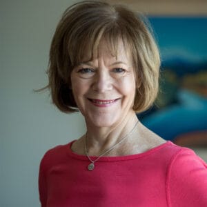 Headshot of Tina Smith wearing a pink shirt.
